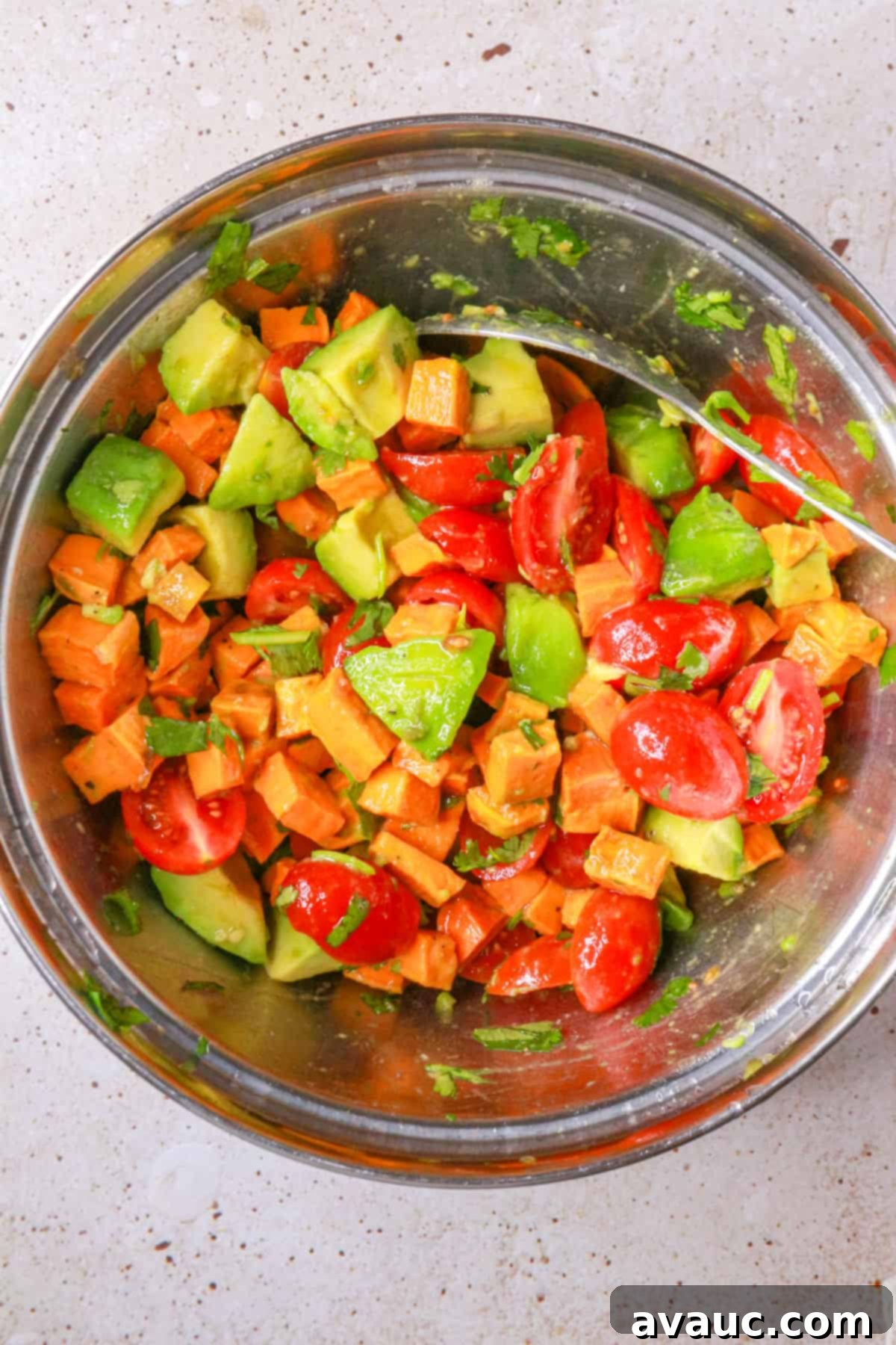 Sweet Potato Avocado Salad 9 sweet potato salad with avocado in a mixing bowl, gently tossed