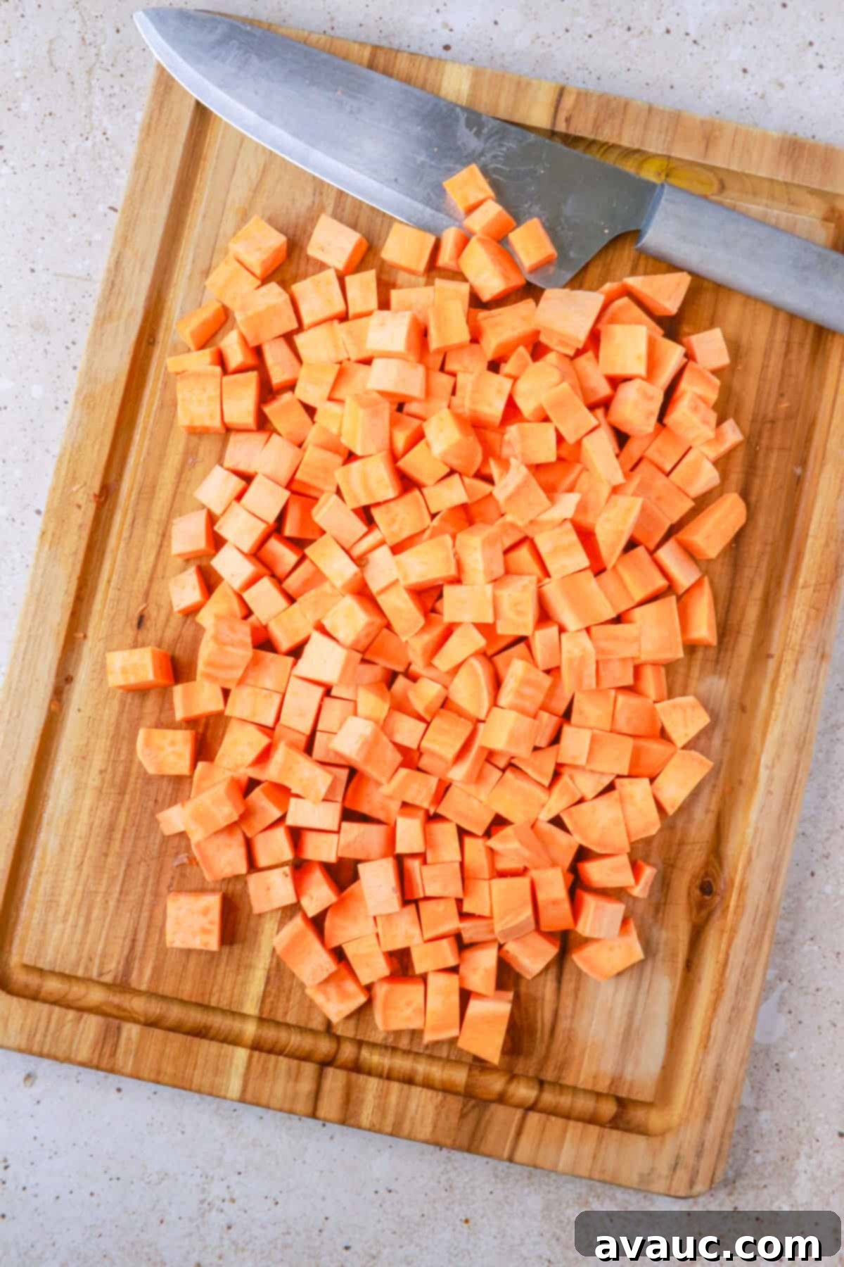 Sweet Potato Avocado Salad 4 diced sweet potatoes on cutting board ready for roasting