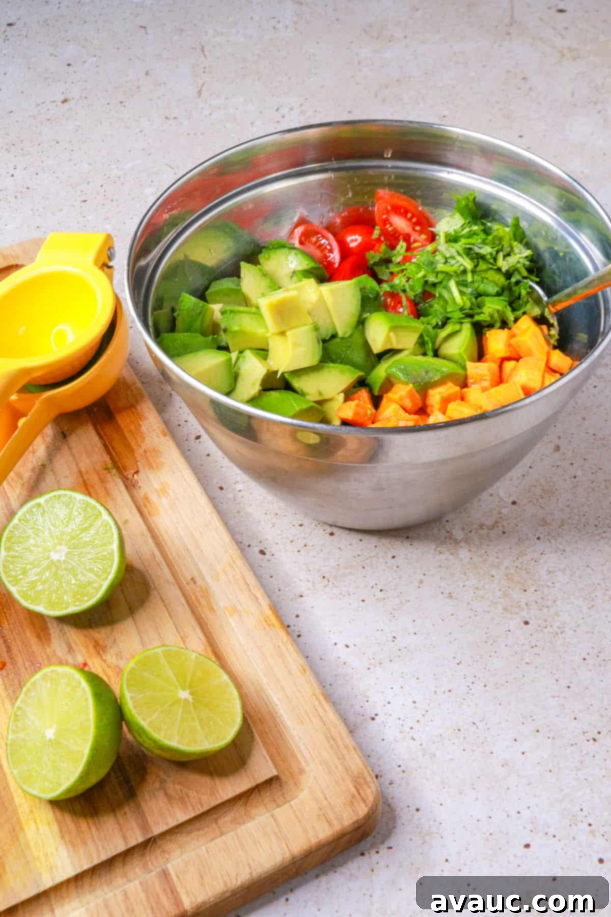 Sweet Potato Avocado Salad 8 Cutting board with cut limes and the sweet potato and avocado salad in the background