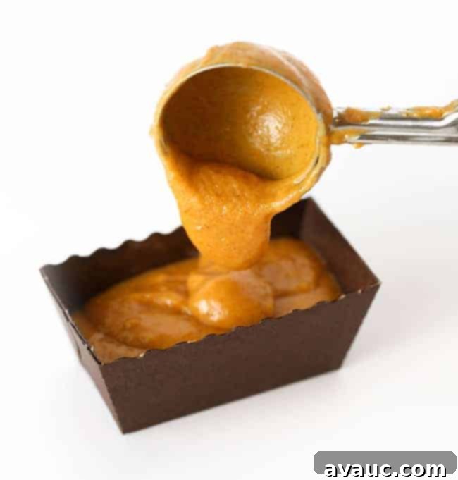 Mini Pumpkin Bread Loaves Recipe Plus Free Gift Tags 6 Scooping batter into mini loaf pans for moist pumpkin bread mini loaf pan recipe, showing ideal portion