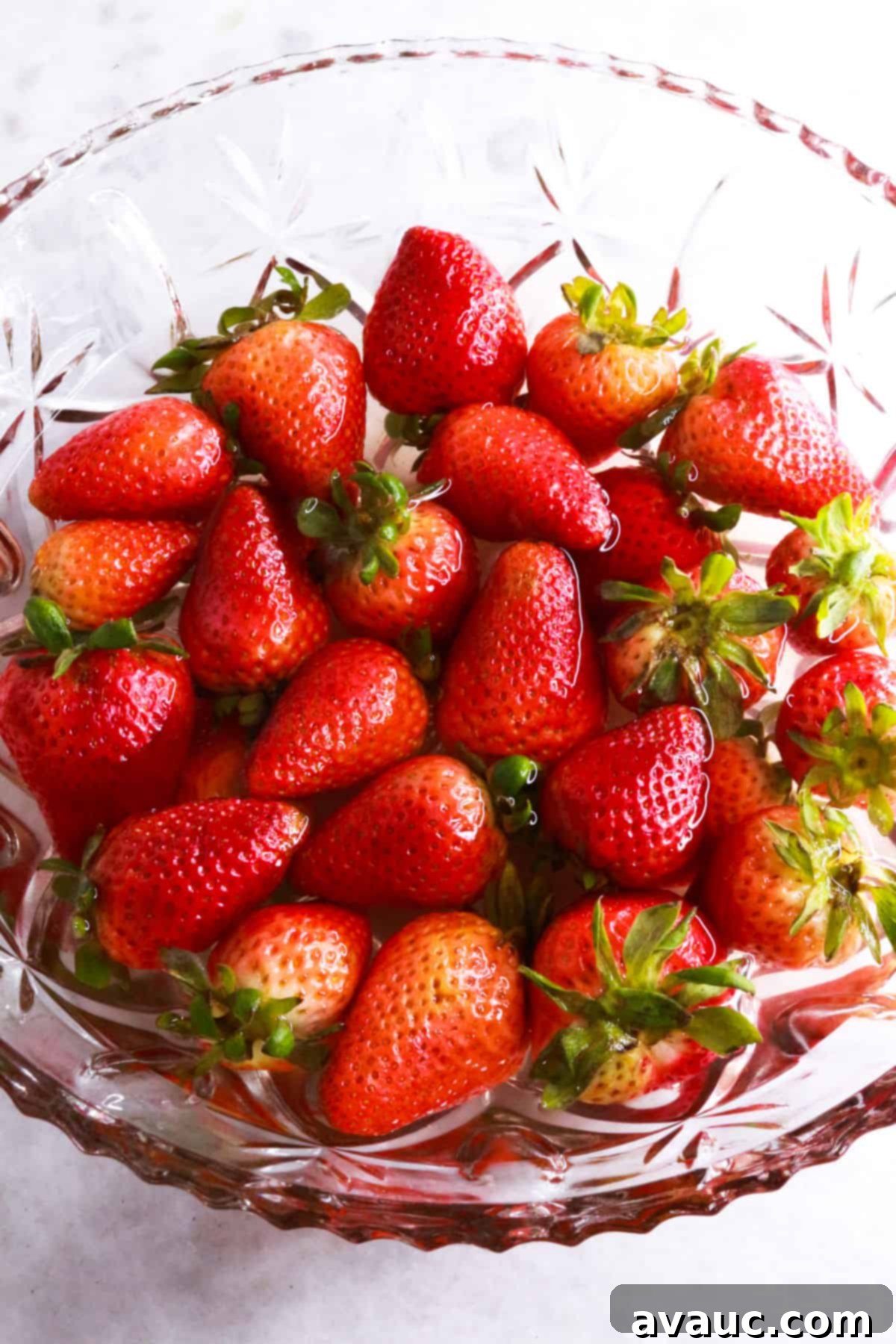 Vegan Strawberry Dream 6 fresh strawberries in vinegar solution in a glass bowl