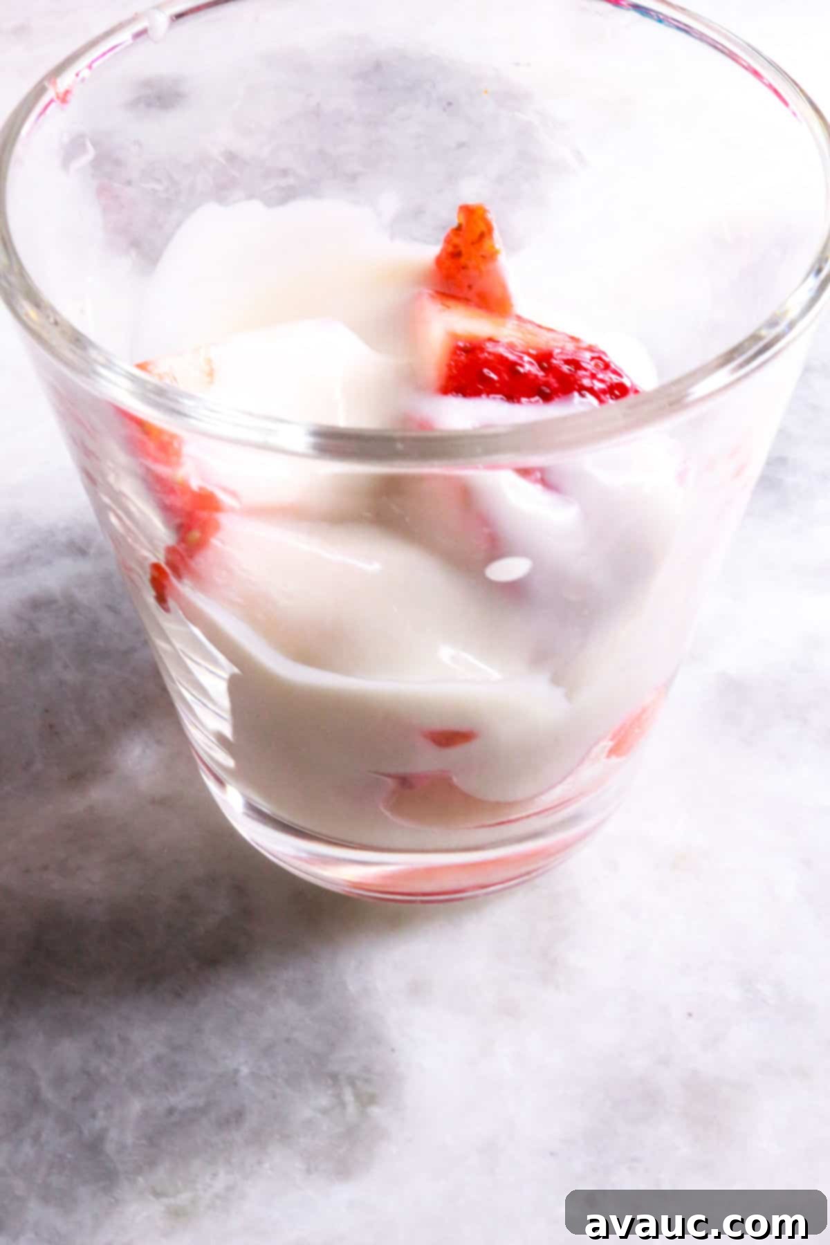 Vegan Strawberry Dream 9 glass jar being filled with layers of fresas con crema