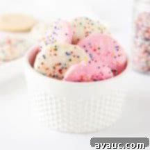 Crispy Frosted Animal Cookie Wafers 10 A top-down view of Homemade Frosted Animal Cookie Wafers on a white background.