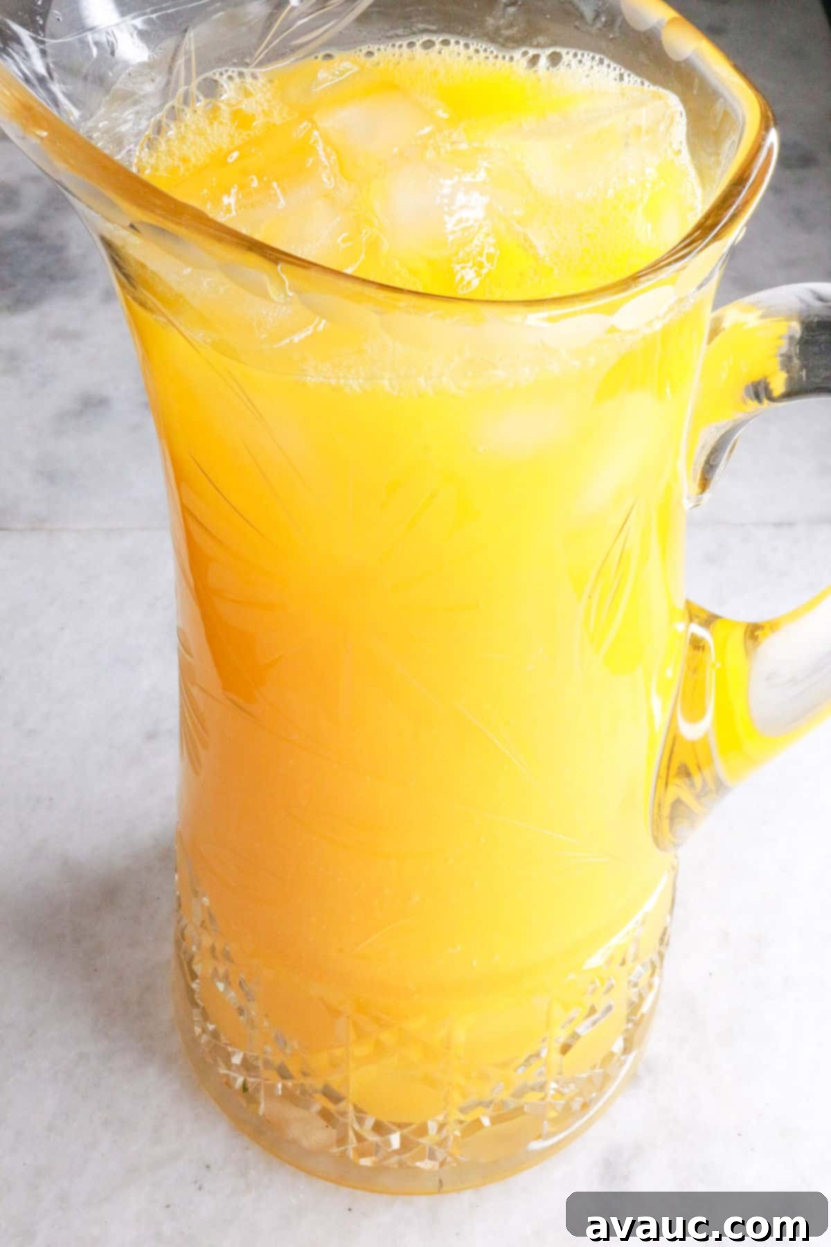 Simple Refreshing Mango Agua Fresca 8 Glass pitcher full of agua de mango with ice