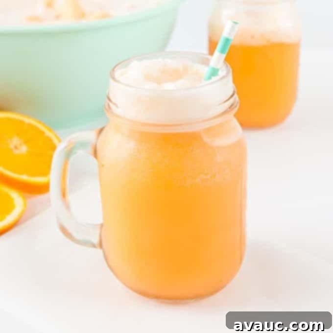 Orange Sherbet Punch, a vibrant orange drink in a glass with a straw