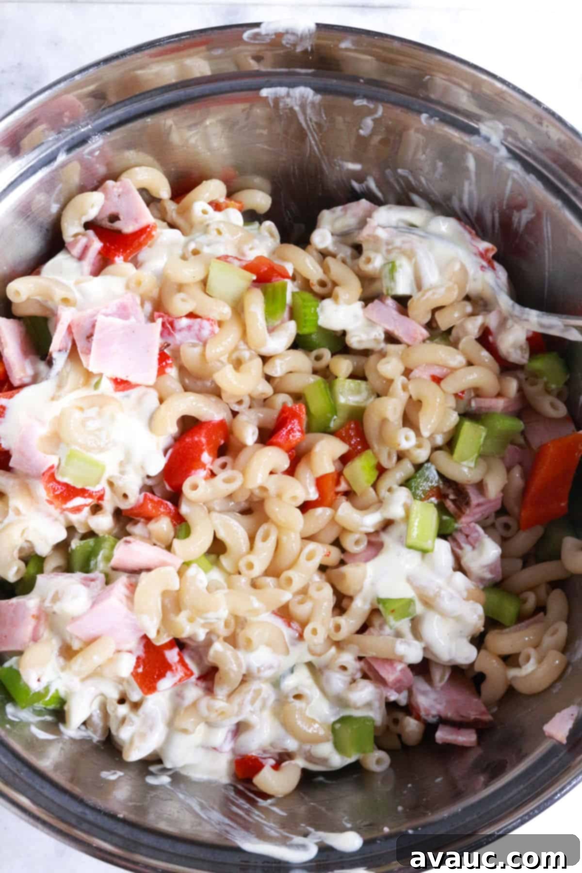 Bowl with ingredients for coditos salad.