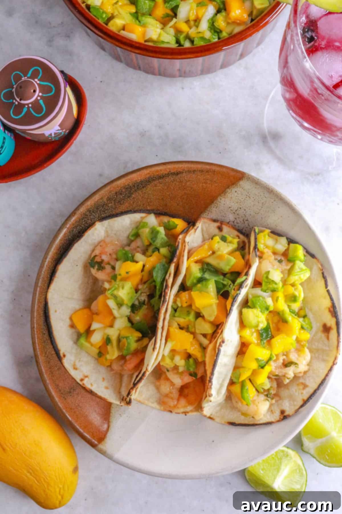 Zesty Shrimp Tacos with Tropical Mango Salsa 9 Top view of a plate with three shrimp tacos with mango salsa