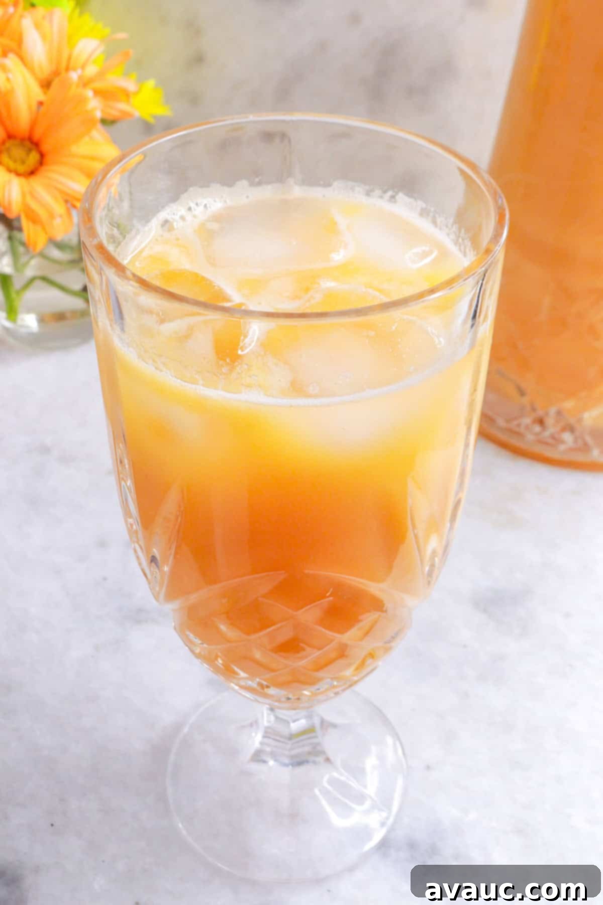 Mexican Melon Refresher 10 Glass with agua de melon with flowers beside it