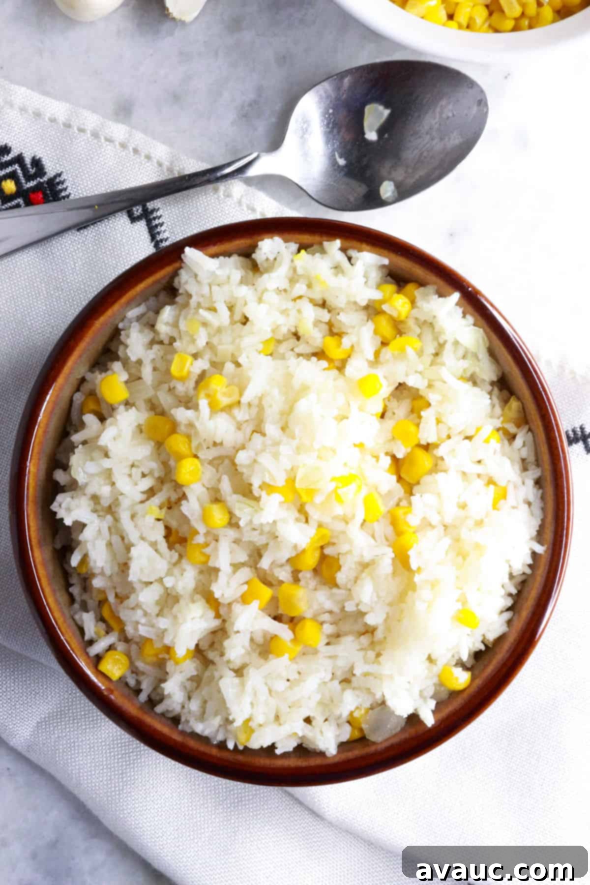Zesty Mexican White Rice with Sweet Corn 9 Top view of a beautifully presented bowl with Mexican white rice with corn on a clean white background