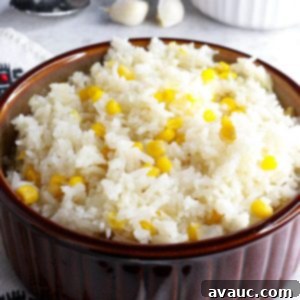 Zesty Mexican White Rice with Sweet Corn 10 Brown bowl with Mexican white rice with corn, garnished