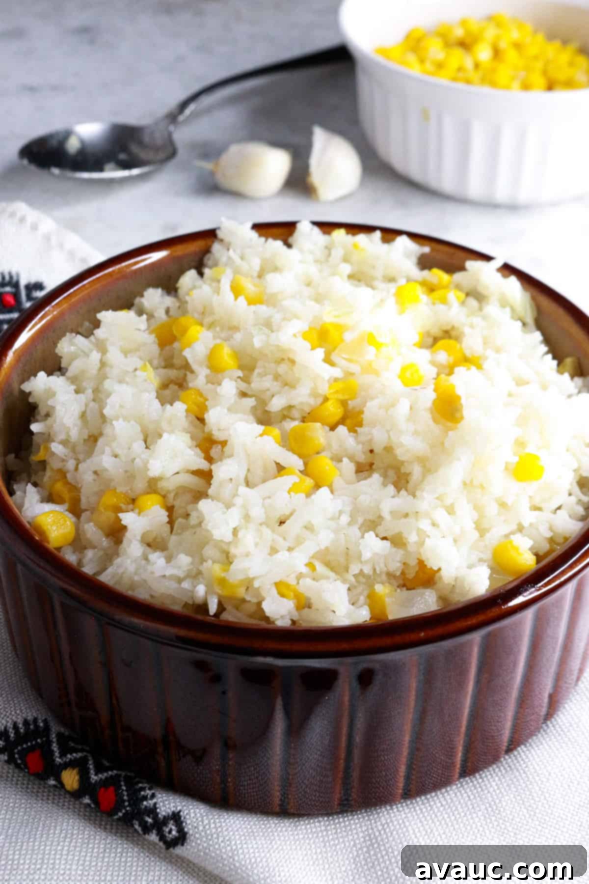 Zesty Mexican White Rice with Sweet Corn 2 Brown bowl with Mexican white rice with corn, garnished and ready to serve