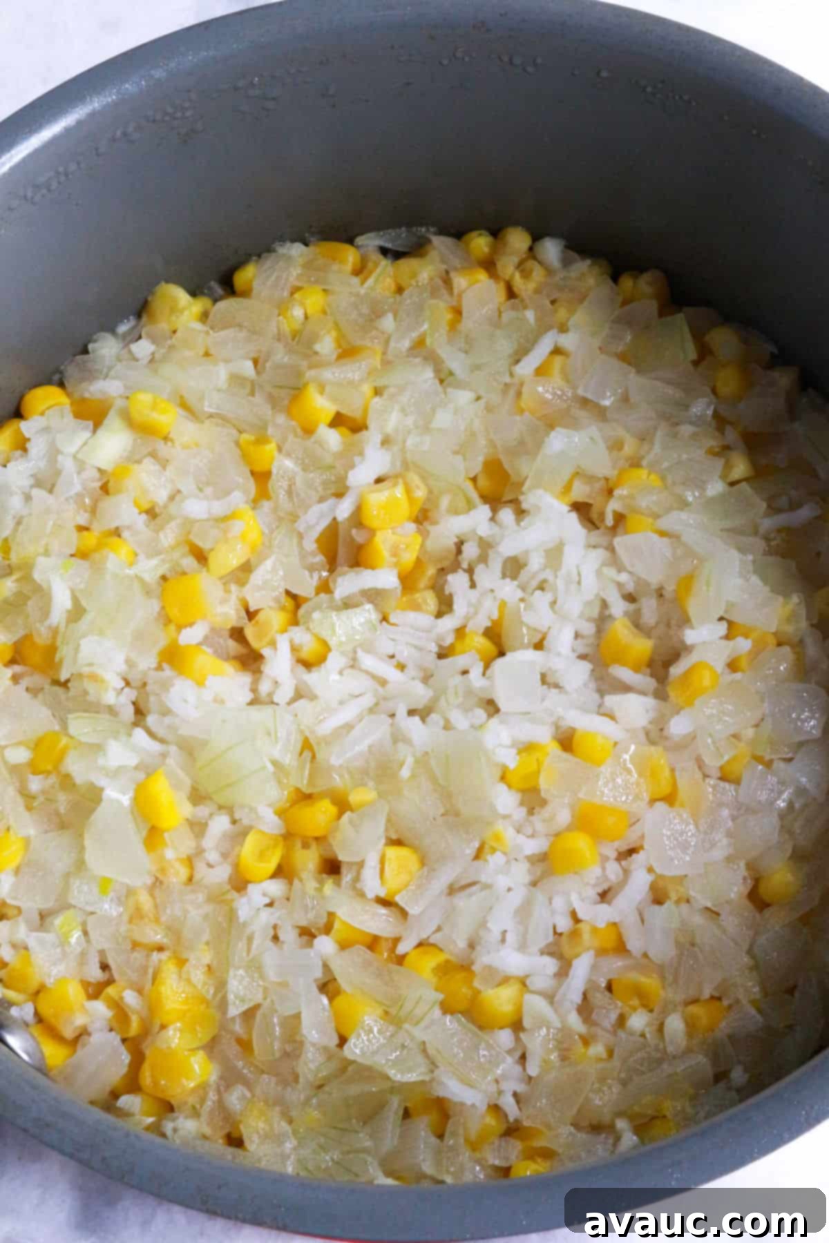 Zesty Mexican White Rice with Sweet Corn 8 Cooked Mexican white rice with corn, Arroz Blanco con Elote, resting in the pan
