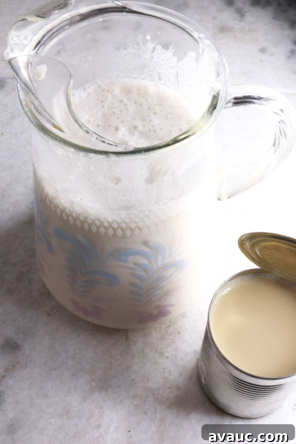Cooling Horchata Delight 8 A glass pitcher filled with prepared horchata, with a can of evaporated milk next to it, ready for final adjustments.