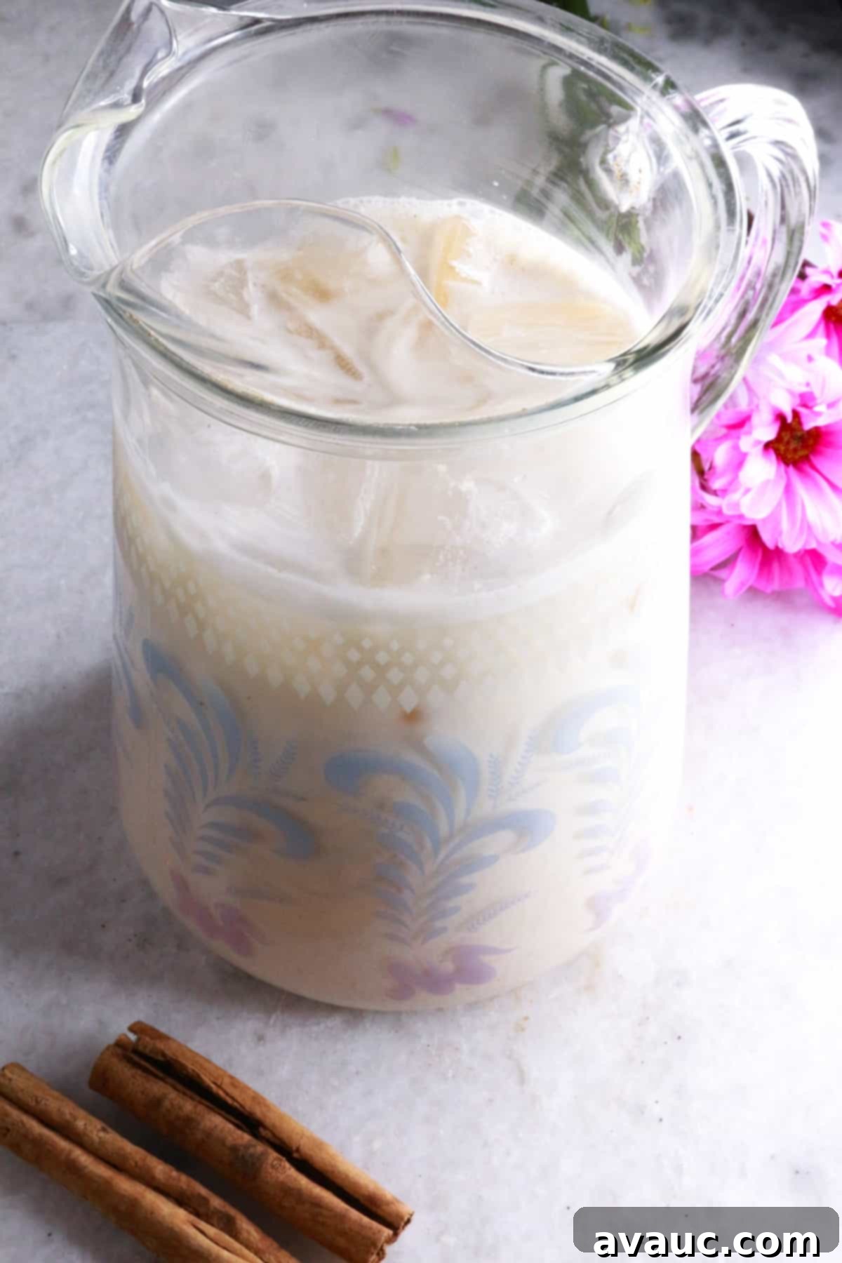 Cooling Horchata Delight 9 A elegant glass pitcher filled with homemade Horchata Agua Fresca, ready to be served and enjoyed.