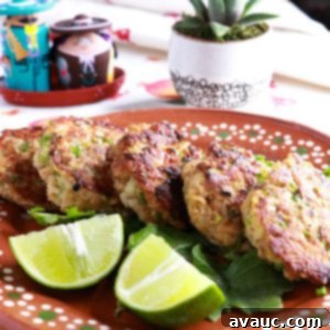 Mexican Tuna Croquettes 9 Plate with croquetas de atun on greens with a side of lime wedges.