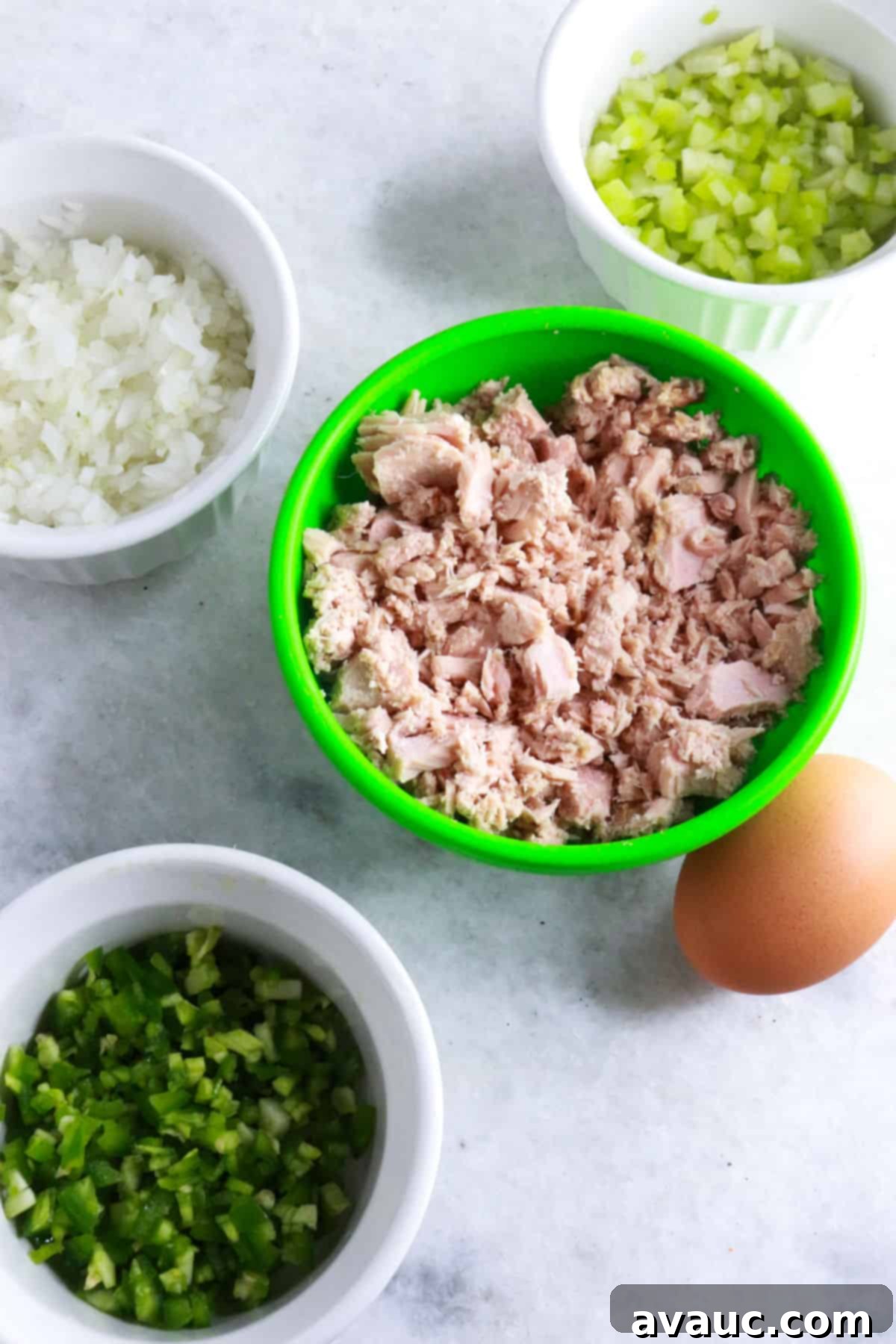 Mexican Tuna Croquettes 3 Bowls with diced onion, diced celery, tuna, and diced jalapeño and a brown egg.