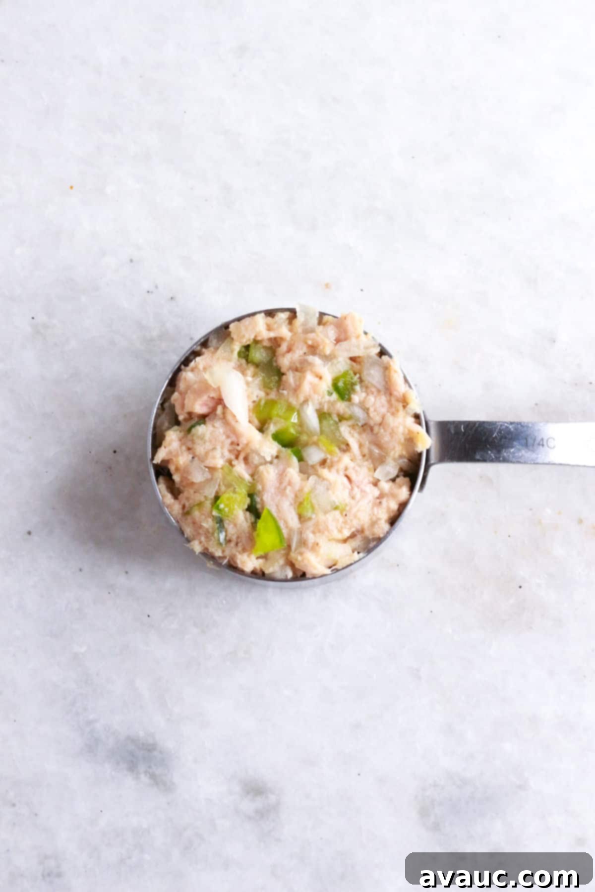 Mexican Tuna Croquettes 6 Measuring cup with the mixture to make Mexican tuna cakes.