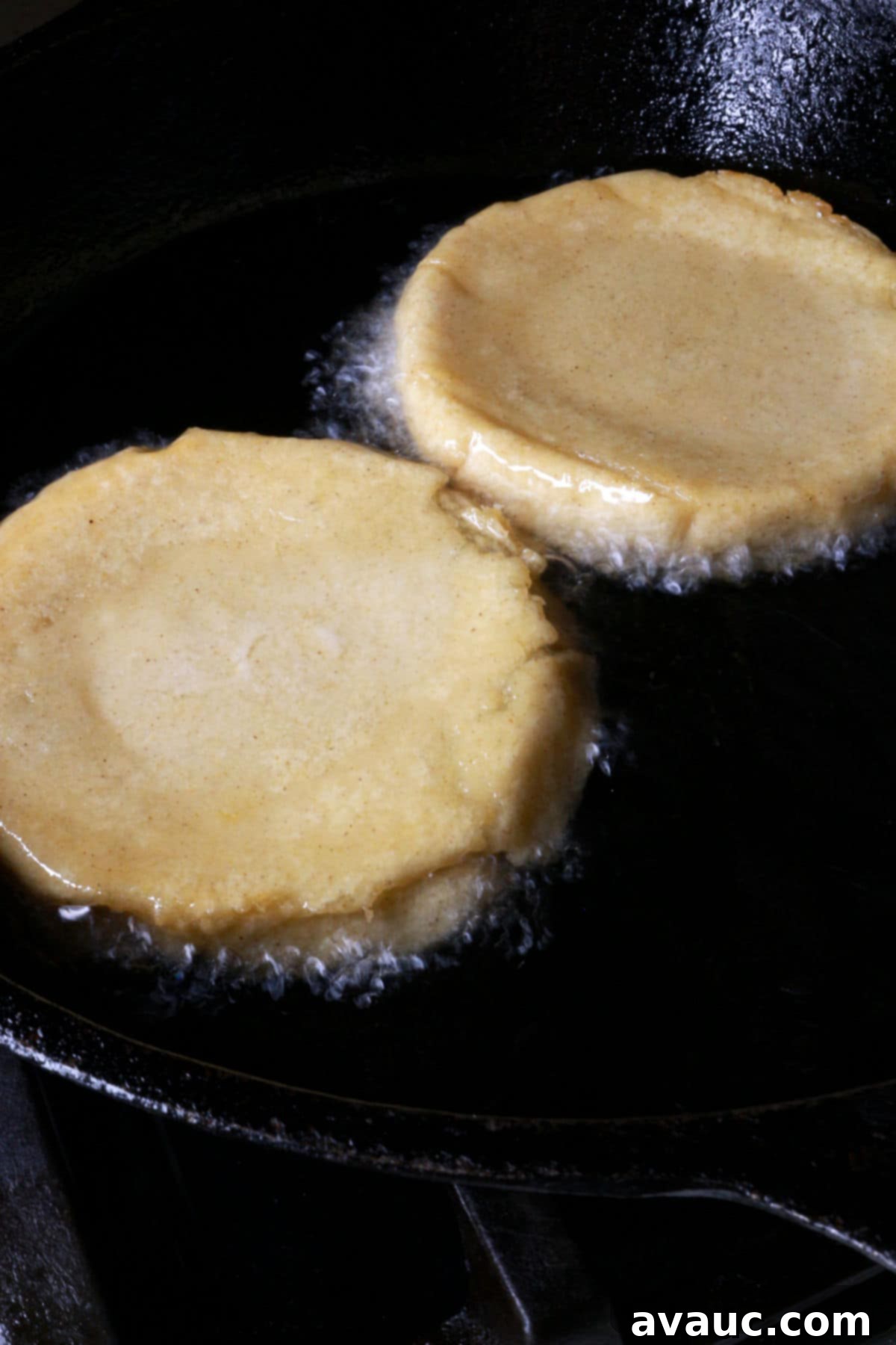 Two sopes flipped face down in a frying pan with hot oil to ensure even crisping