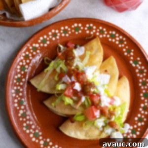 Crunchy Golden Chicken Tacos 13 Three tacos dorados de pollo on a brown Mexican plate topped with garnishes