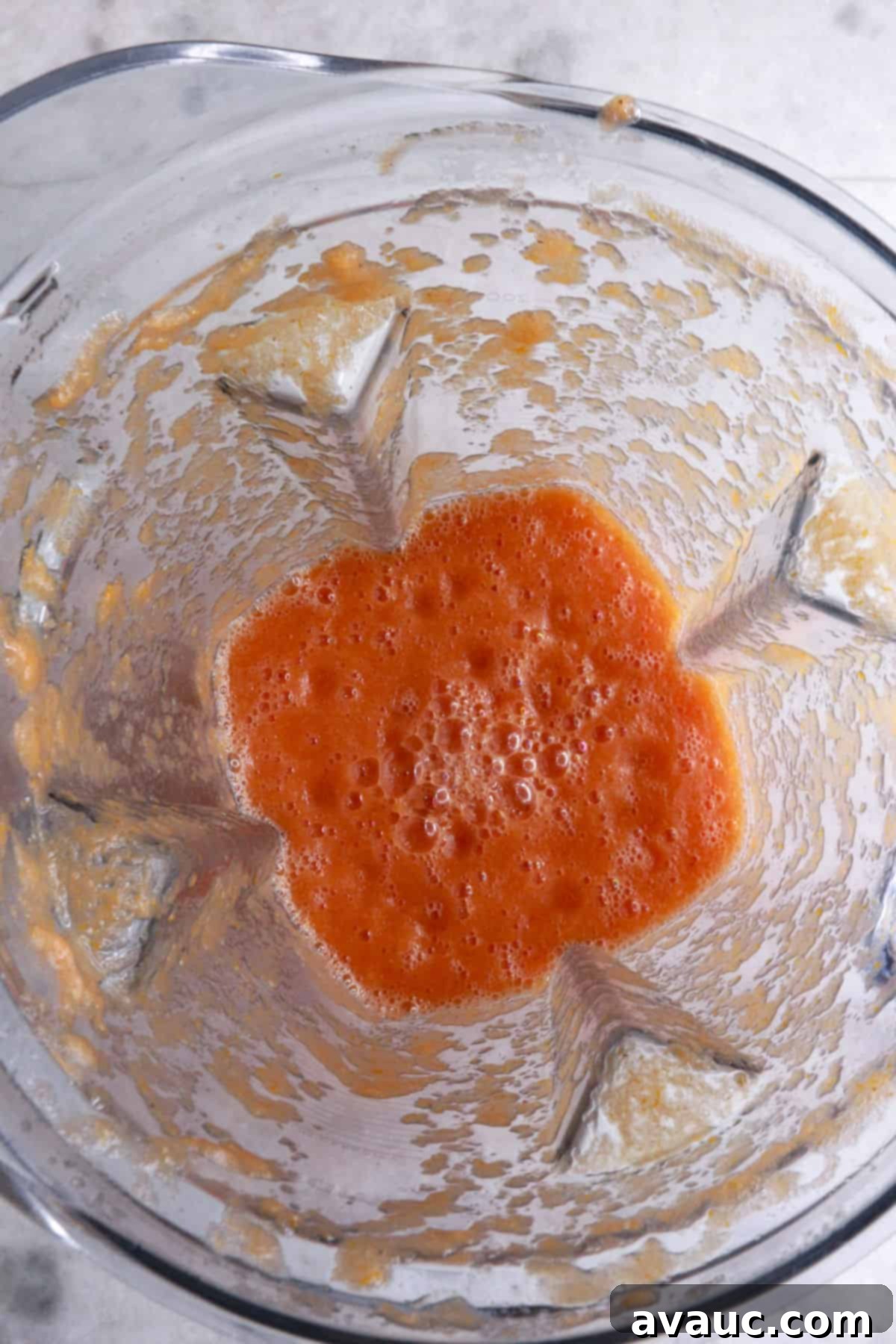 Crunchy Golden Chicken Tacos 7 A blender containing vibrant, freshly prepared smooth tomato sauce, ready to be incorporated into the chicken filling
