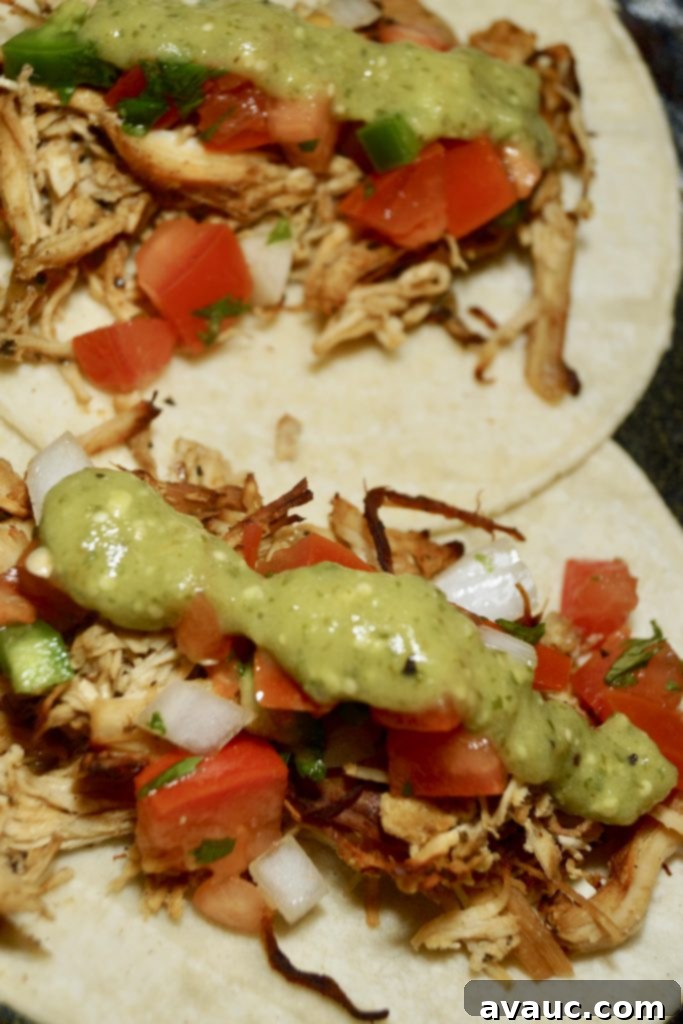 Close-up of crispy shredded Whole30 chicken tacos in a bowl, ready to be assembled into lettuce wraps. #whole30slowcookercrispychickentacos #chickentacos #healthymeal