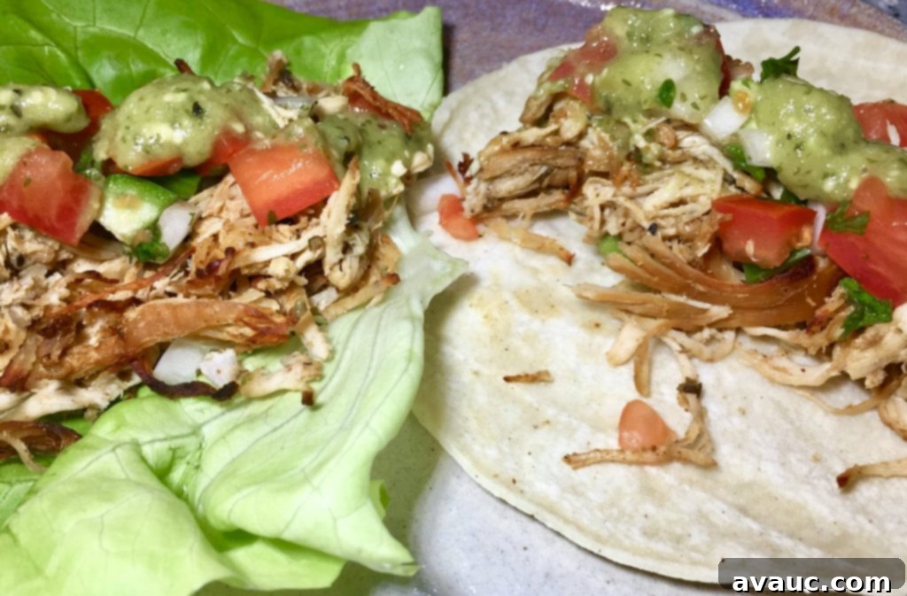 Arranged Whole30 slow cooker crispy chicken tacos on lettuce leaves with a side of fresh salsa, ready to be enjoyed. #whole30slowcookercrispychickentacos #chickentacos #lettucetacos #healthytacos