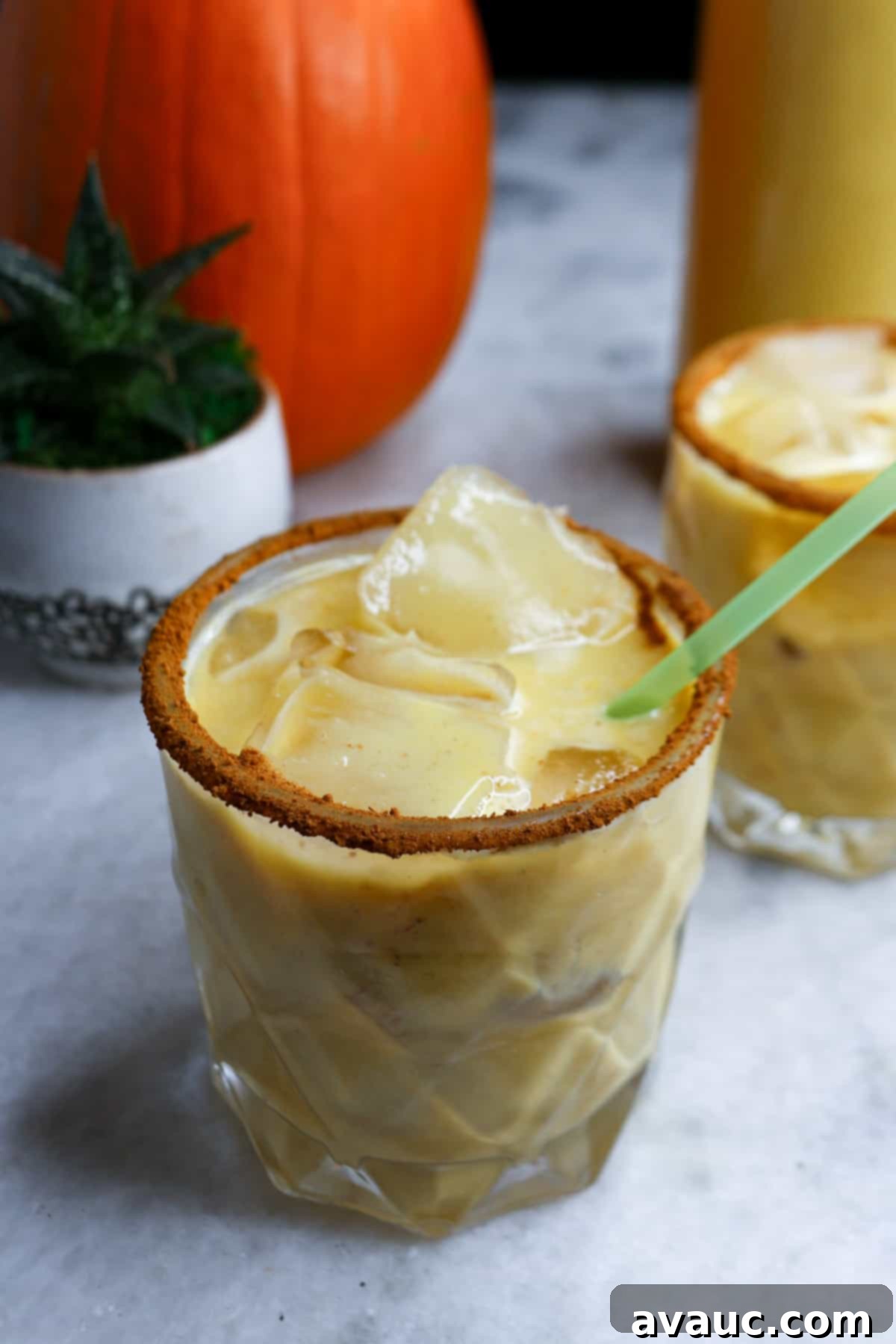 Fall Pumpkin Spice Horchata 2 Pumpkin Spice Horchata in a clear glass with a green straw, ready to be enjoyed