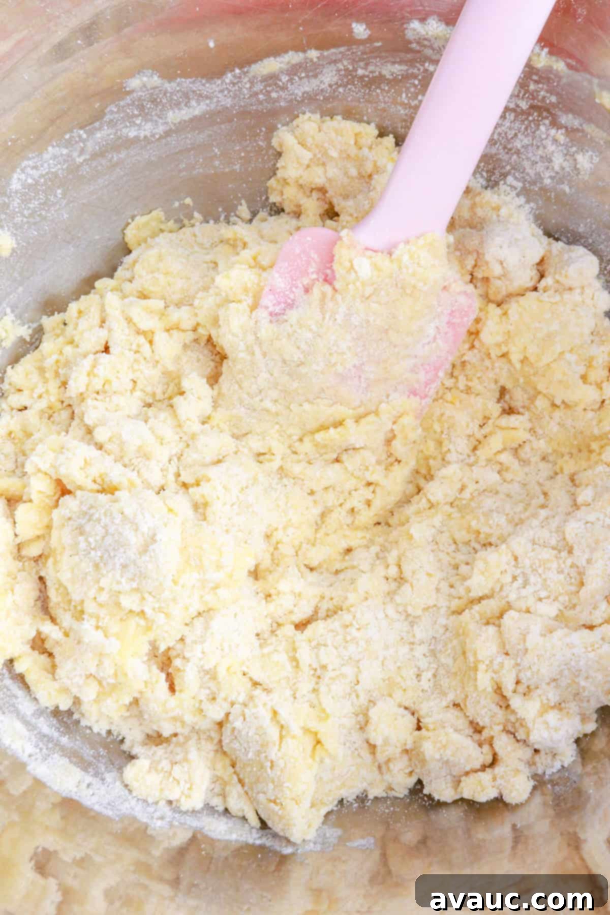 Mixing wet and dry ingredients in a bowl with a spatula
