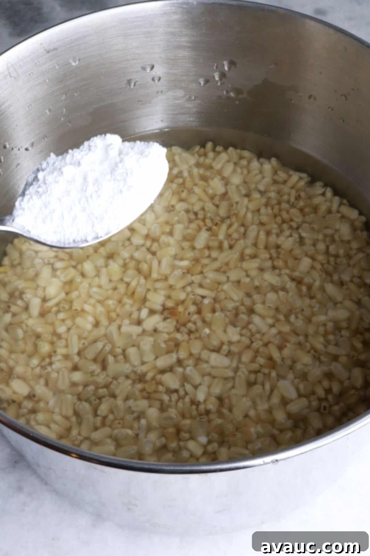 Mastering Nixtamalization for Authentic Tamales 5 Adding a spoonful of food-grade cal to a large pot filled with water and dried corn kernels.