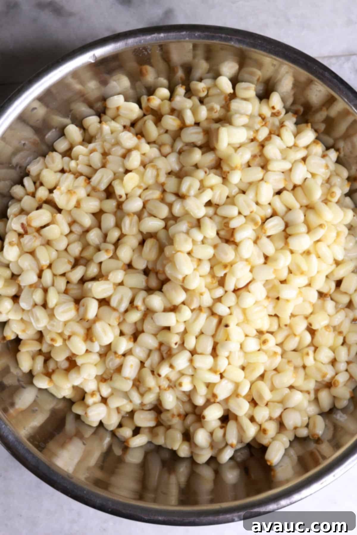 Mastering Nixtamalization for Authentic Tamales 7 Nixtamalized corn kernels, clean and softened after rinsing, ready for grinding into masa.