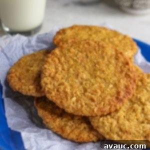 Coconut flour oatmeal cookies on a blue plate with a glass of milk behind it.