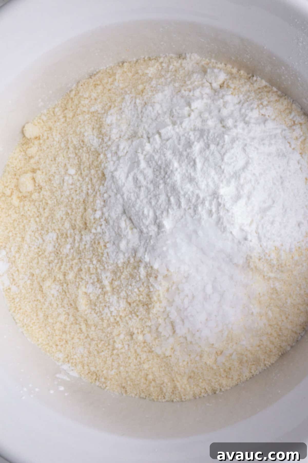 A bowl containing mixed dry ingredients for coconut flour cookies: coconut flour, salt, and baking powder.