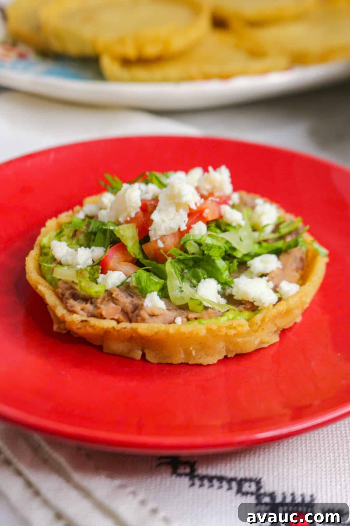 Classic Refried Bean Sopes 2 Sope de frijoles on a red plate