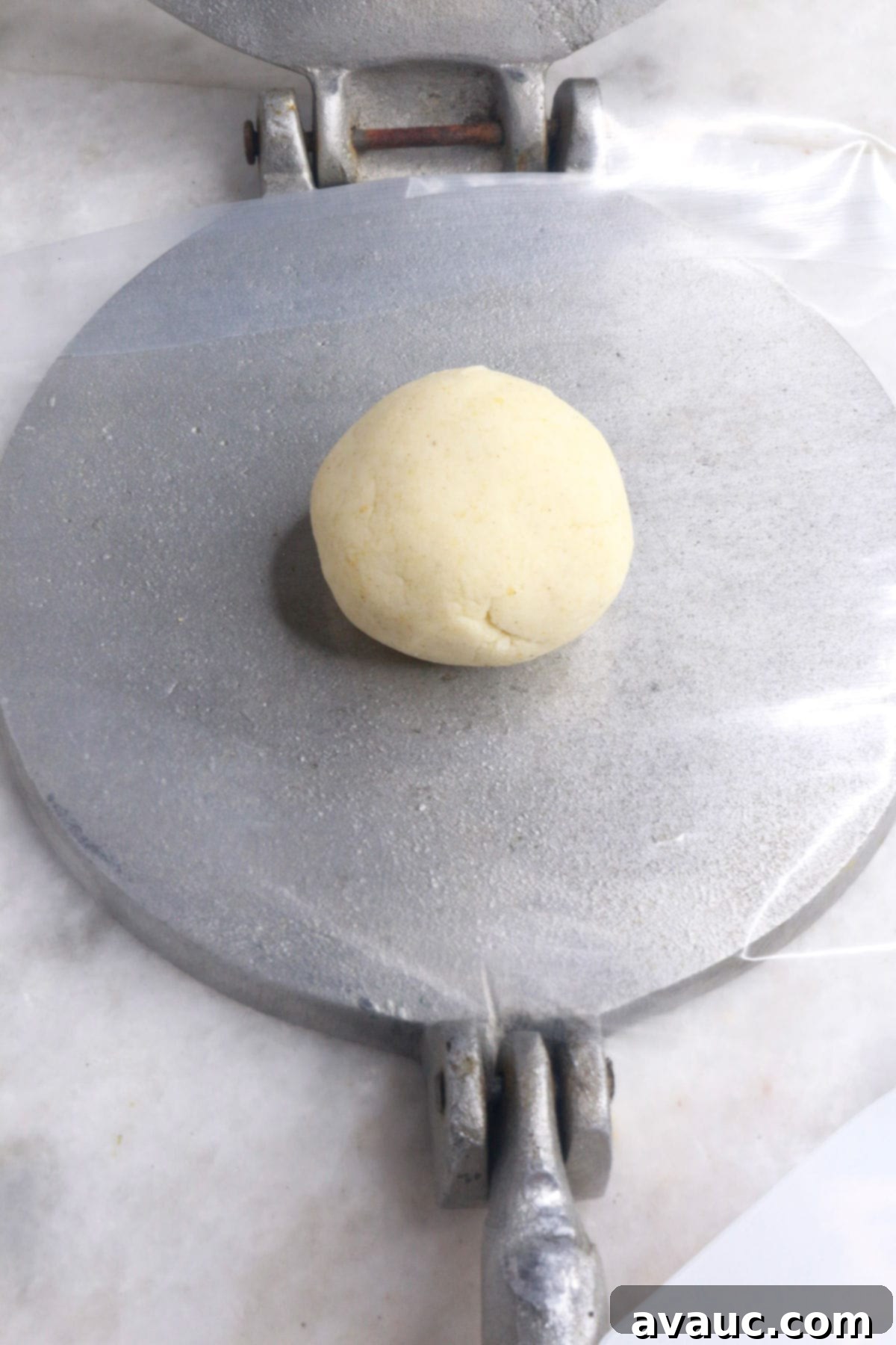 Classic Refried Bean Sopes 6 Ball of masa dough on an open tortilla press