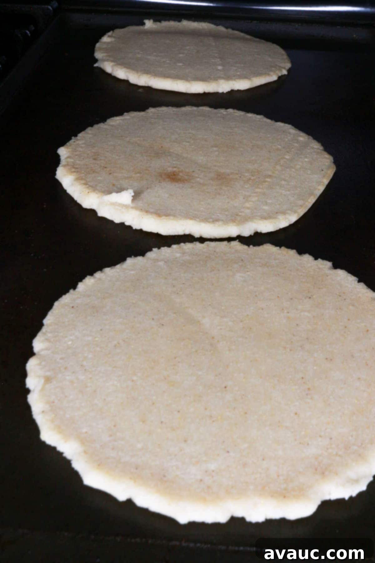Classic Refried Bean Sopes 7 Three thick corn tortillas on a comal