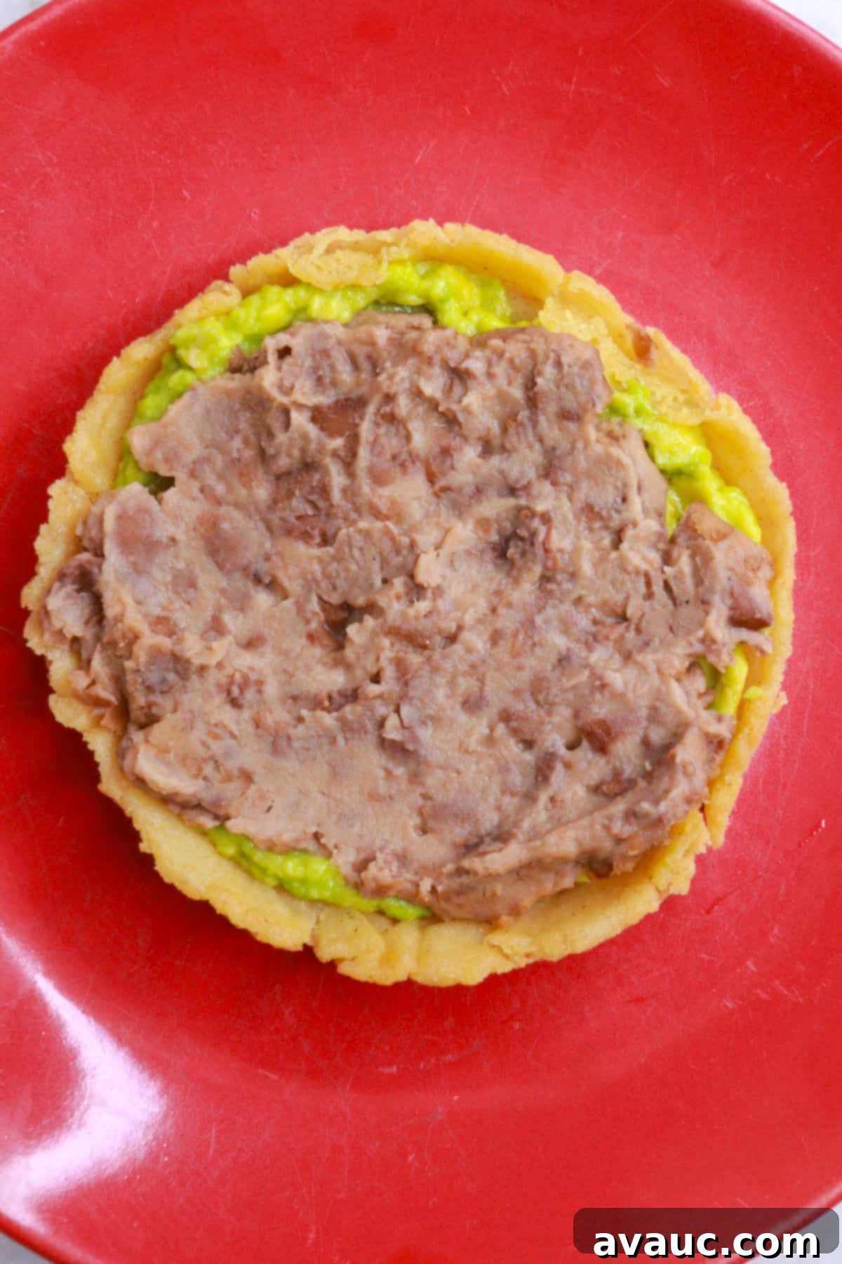 Classic Refried Bean Sopes 10 A sope topped with mashed avocado and refried beans