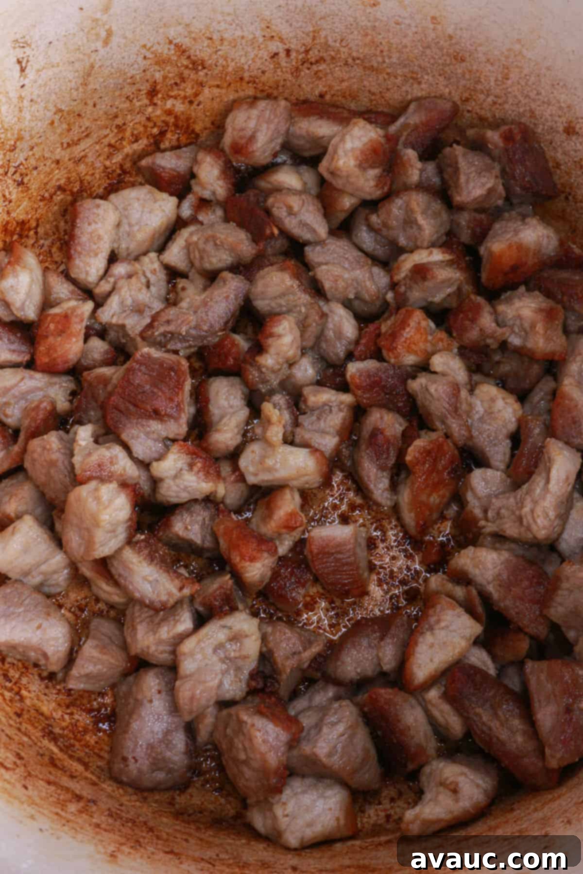 Slow-Cooked Red Chile Pork 7 Pieces of golden-brown pork in a pot