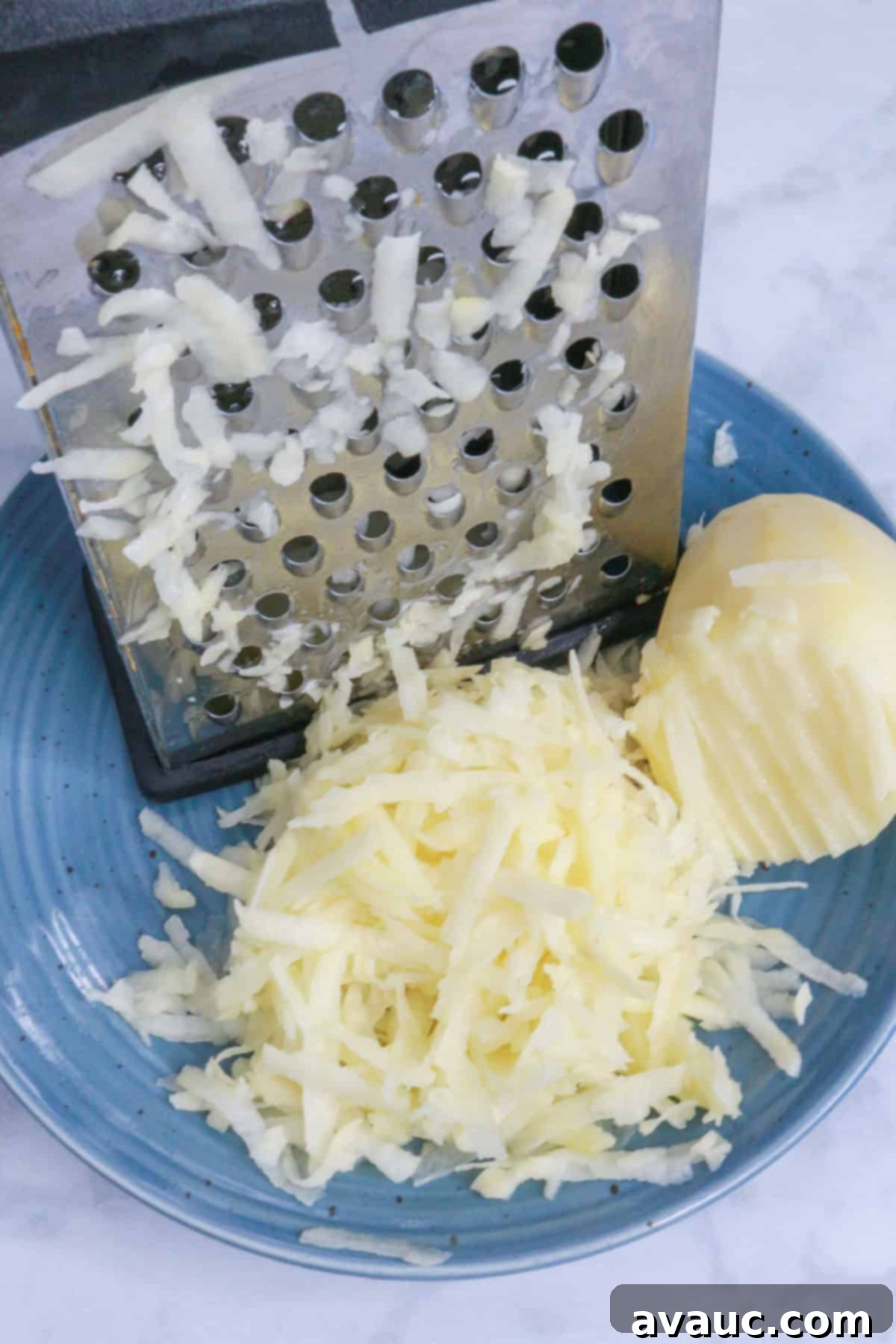 Golden Crispy Potato Tacos 6 Grating a potato with a box grater