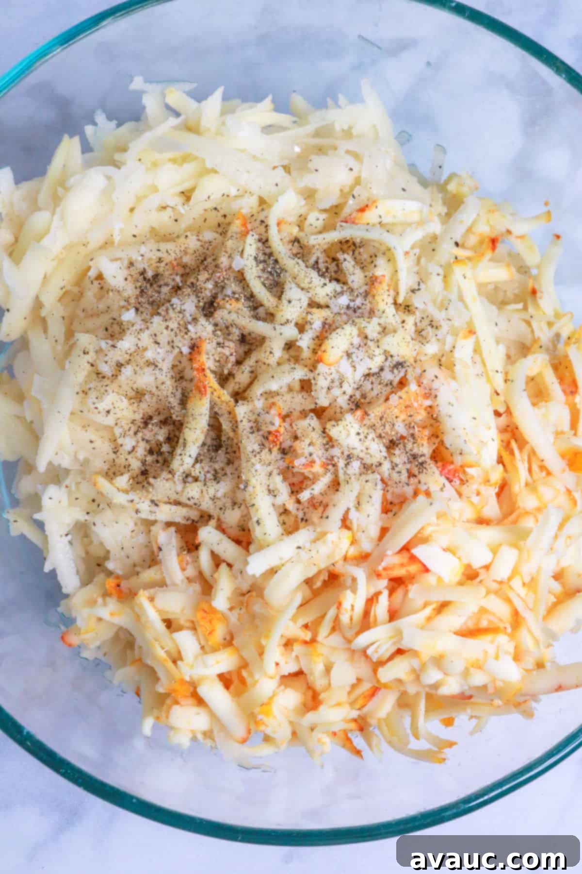 Golden Crispy Potato Tacos 7 Shredded potatoes, shredded cheese and salt and pepper in a bowl
