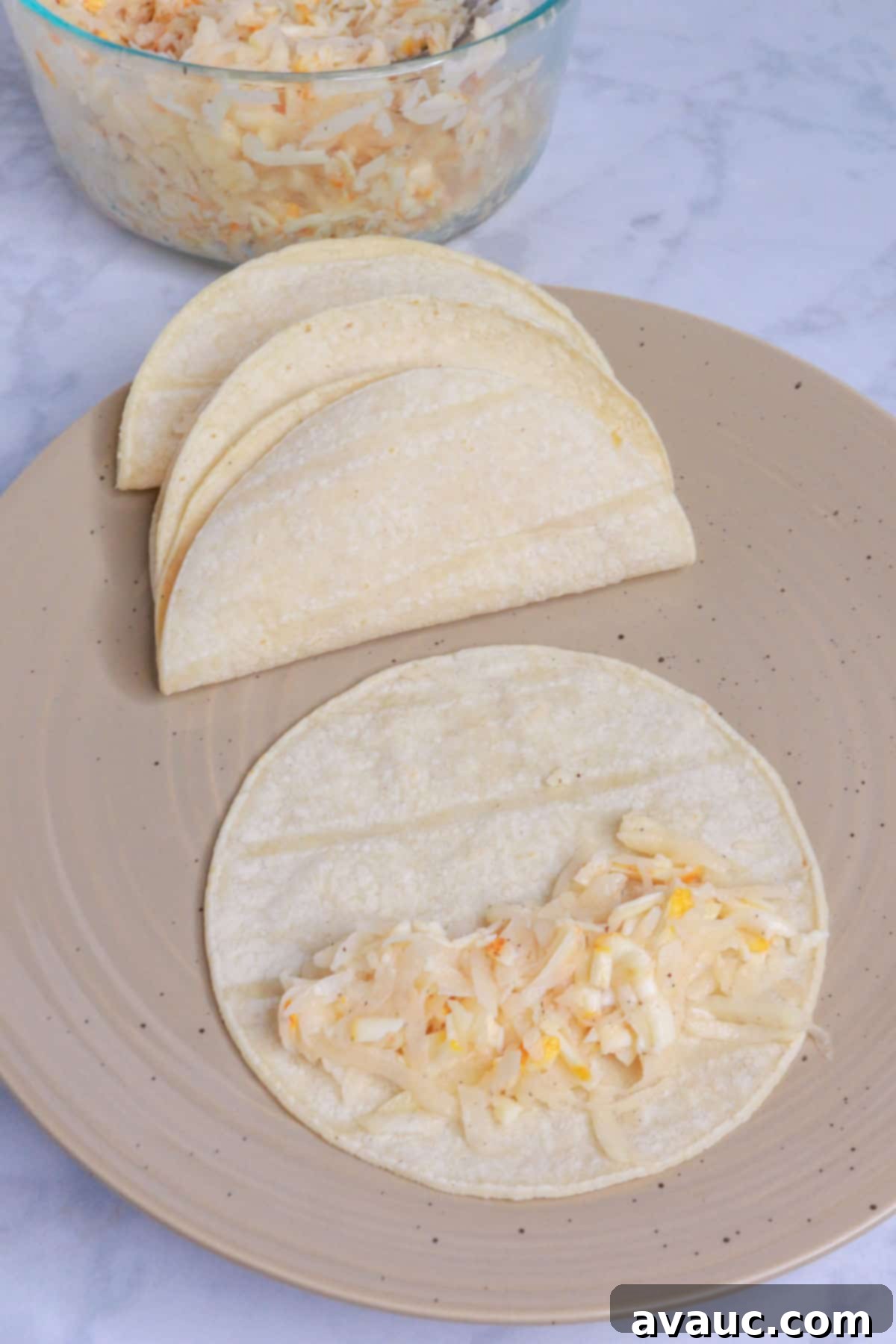 Golden Crispy Potato Tacos 8 Placing potato mixture on corn tortillas for potato tacos