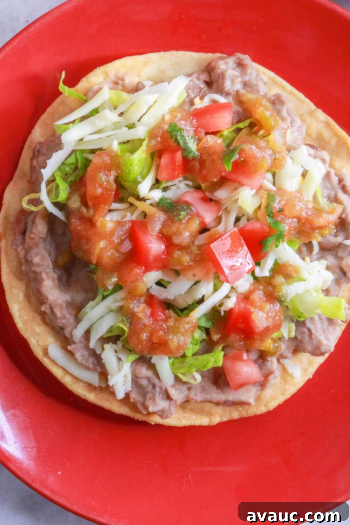 Crispy Bean Tostadas 9 A bean tostada with lettuce, cheese, tomatoes and salsa