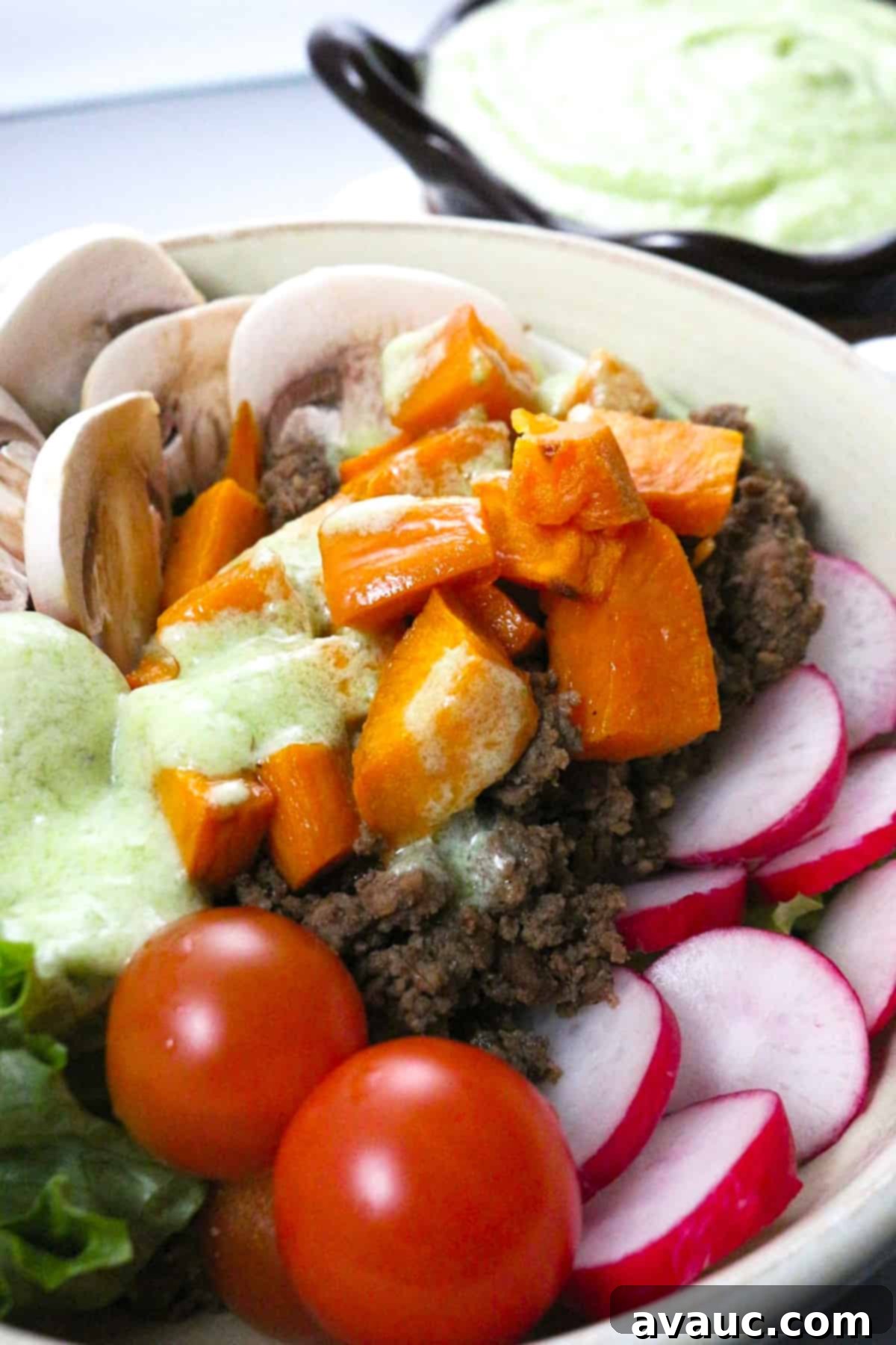 Vibrant Sweet Potato Taco Bowl 9 A beautifully plated Sweet Potato Taco Bowl with the coconut-lime jalapeño dressing in the background.
