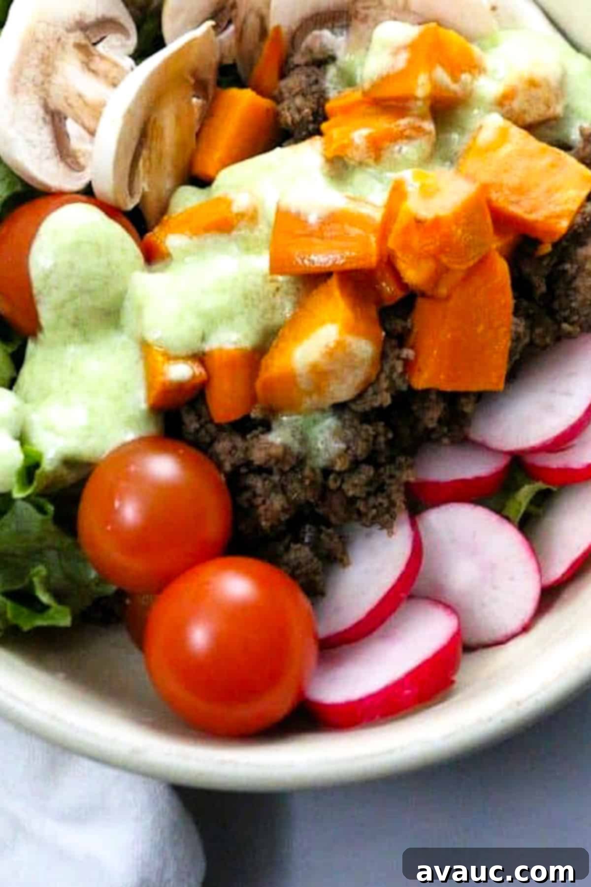 Vibrant Sweet Potato Taco Bowl 2 A delicious Sweet Potato Taco Bowl with ground beef, roasted sweet potatoes, and fresh vegetables, drizzled with a creamy coconut-lime jalapeño dressing.