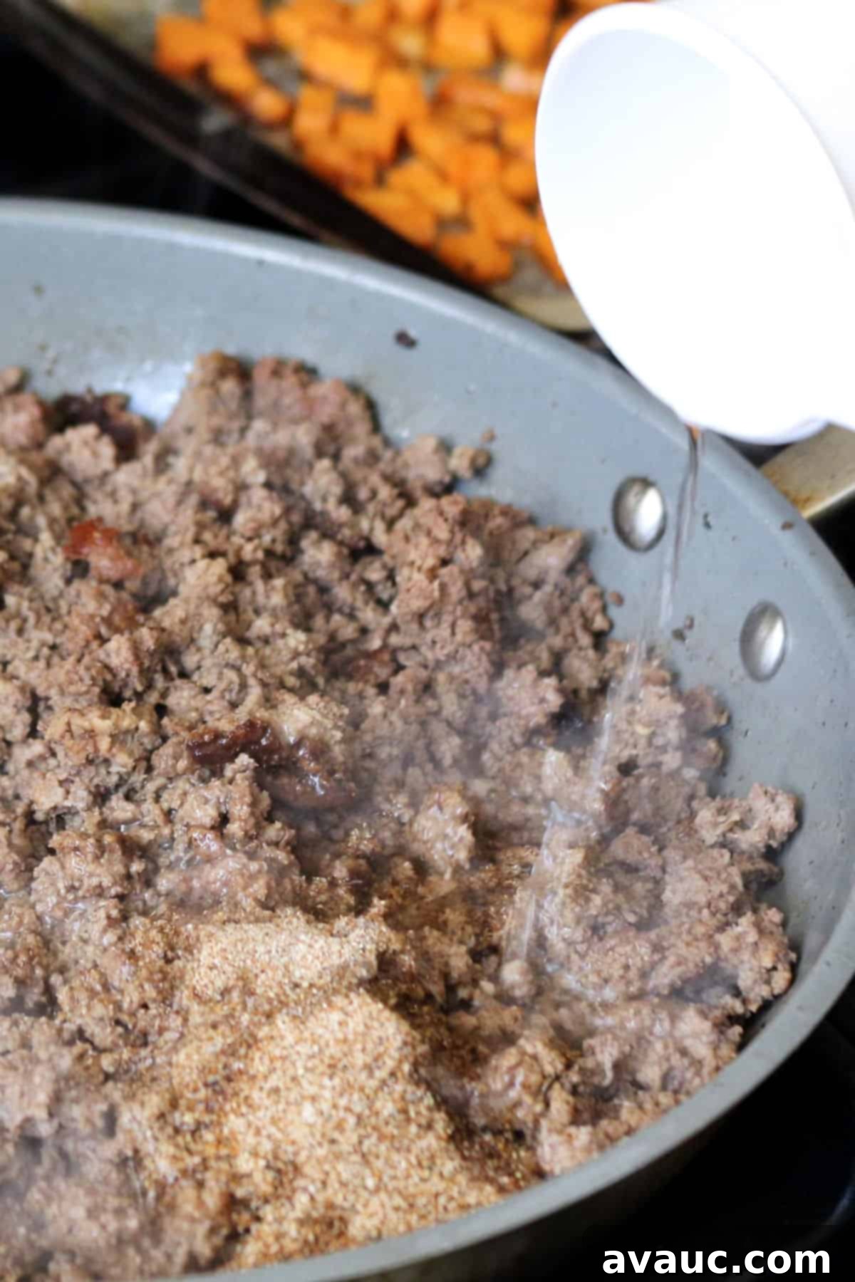 Vibrant Sweet Potato Taco Bowl 8 Adding water to ground beef with taco seasoning for a rich sauce.