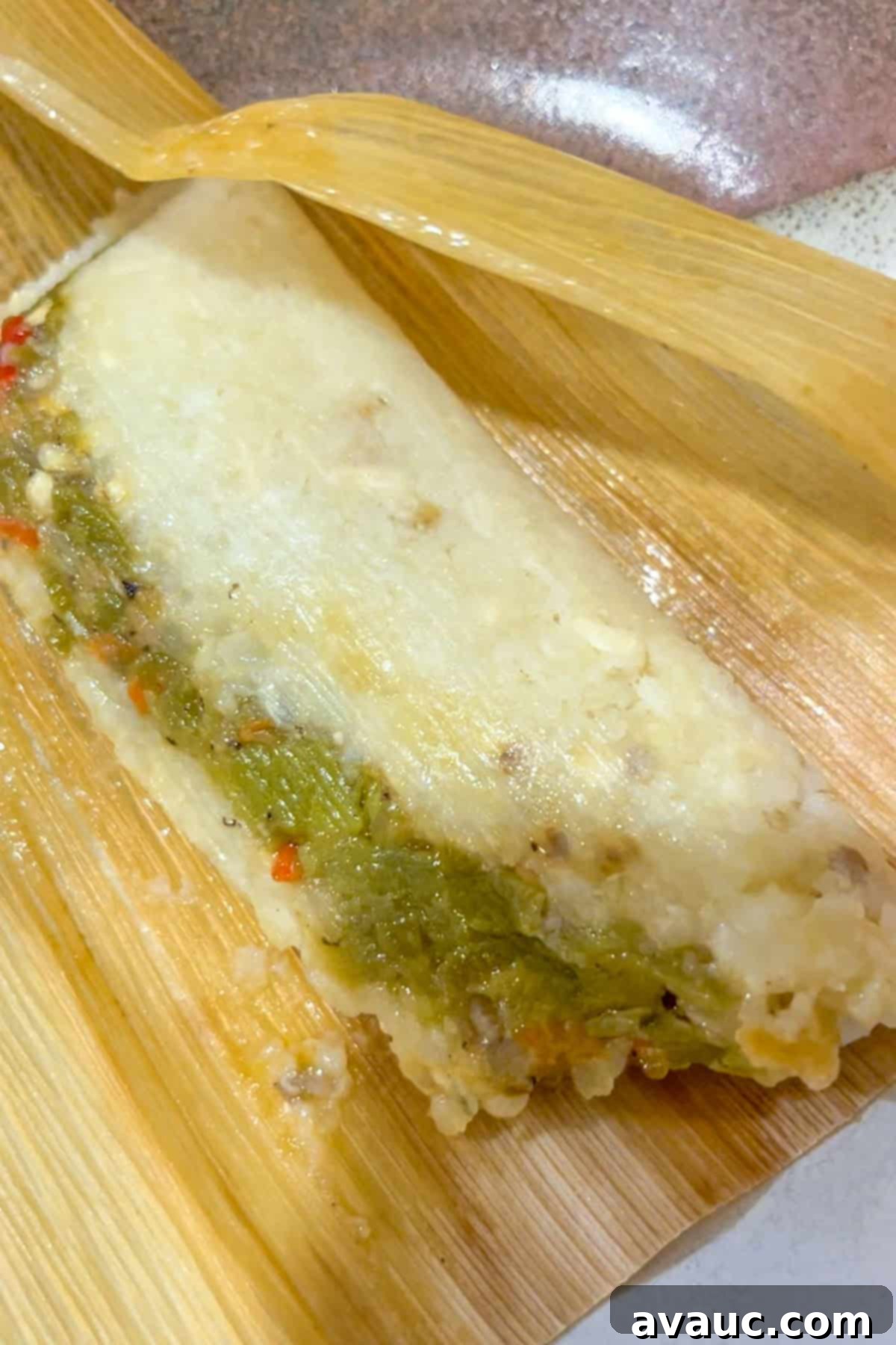 Open green chile and cheese to test for doneness