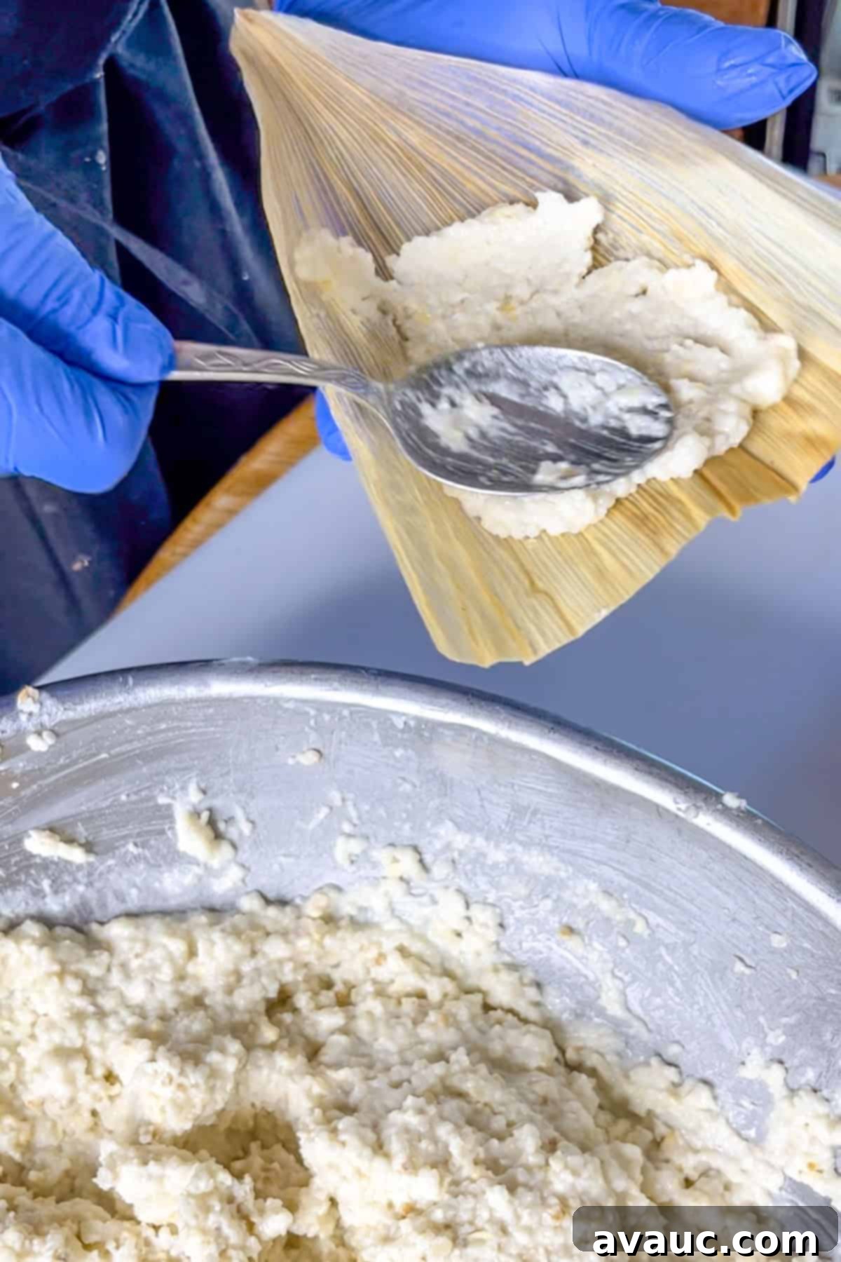 Spreading the tamal masa on a corn husk