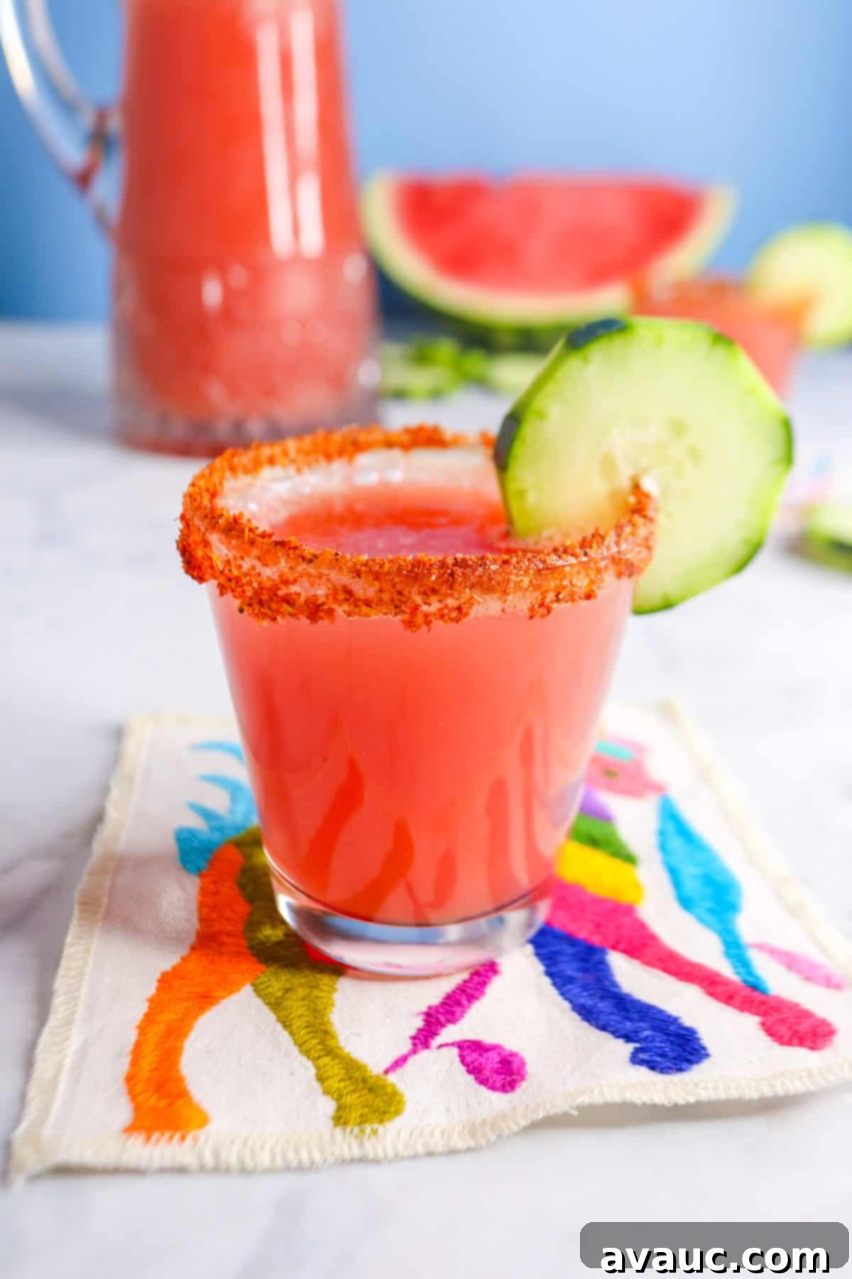 Vibrant Cucumber Watermelon Cooler 2 Vibrant cucumber watermelon agua fresca served in a glass, garnished with fresh cucumber slices and a wedge of watermelon.