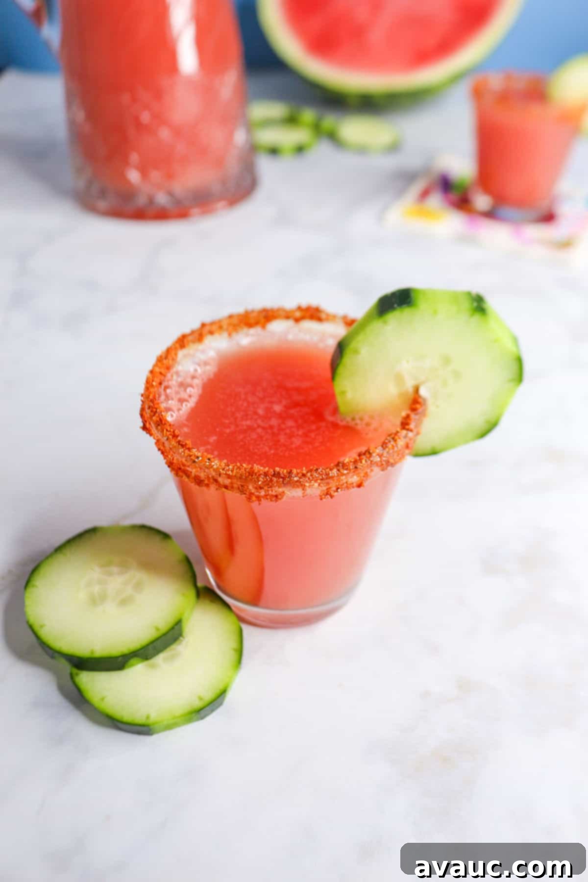Vibrant Cucumber Watermelon Cooler 10 A refreshing glass of Agua de Pepino y Sandia (Cucumber Watermelon Agua Fresca) with a decorative cucumber ribbon garnish.
