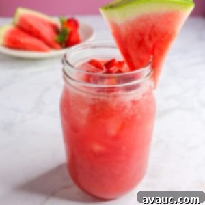 Watermelon Strawberry Agua Fresca 11 A beautifully presented glass of Watermelon Strawberry Agua Fresca, garnished with a fresh watermelon slice, inviting and refreshing.