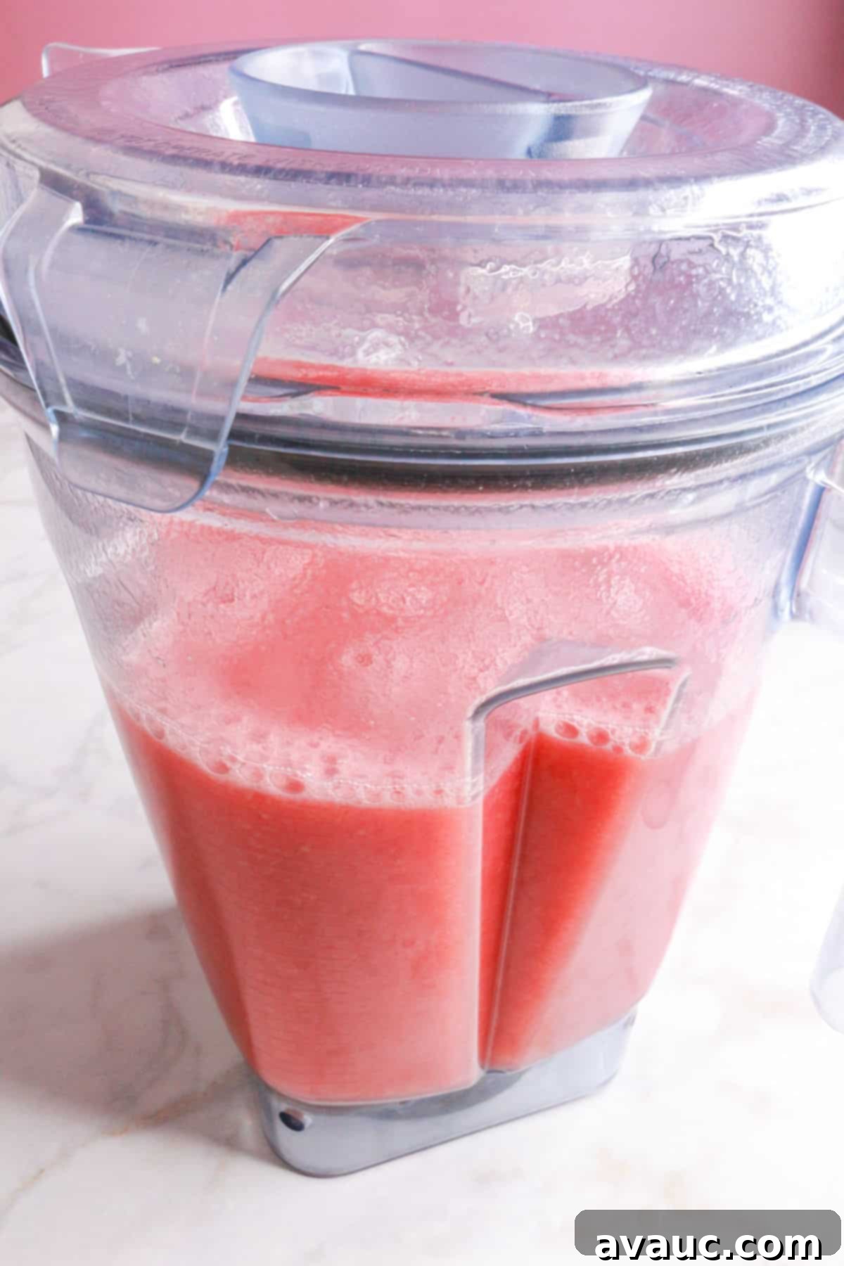 Watermelon Strawberry Agua Fresca 7 The vibrant red Watermelon Strawberry Agua Fresca, freshly blended and frothy, resting in a blender, ready for the next step.